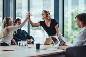 Titre Professionnel REM – Responsable d’établissement marchand – Evoya Academy Équipe participant à une réunion animée par une responsable d’établissement marchand